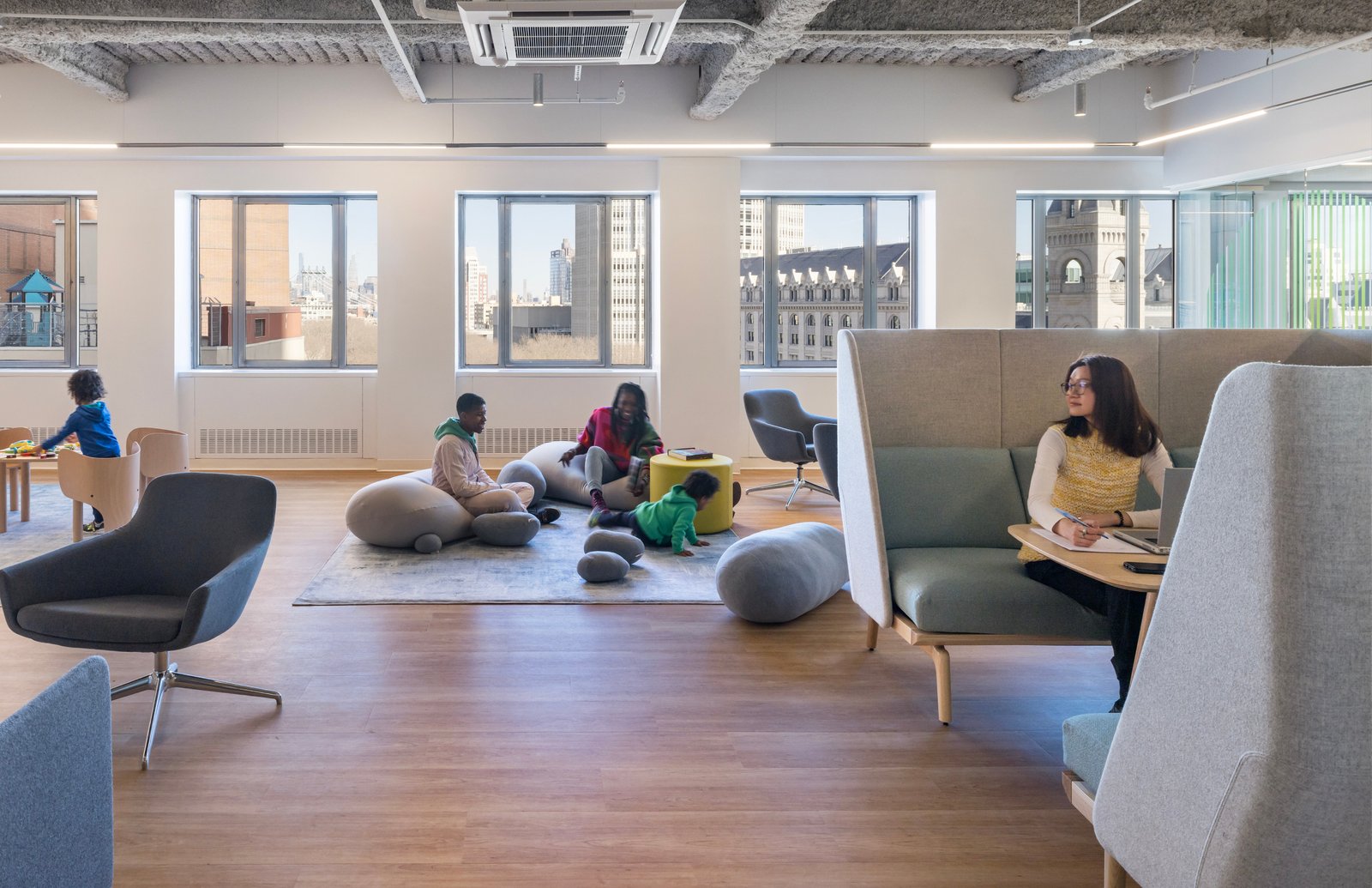 Open lounge area with play space and seating for work or relaxation.